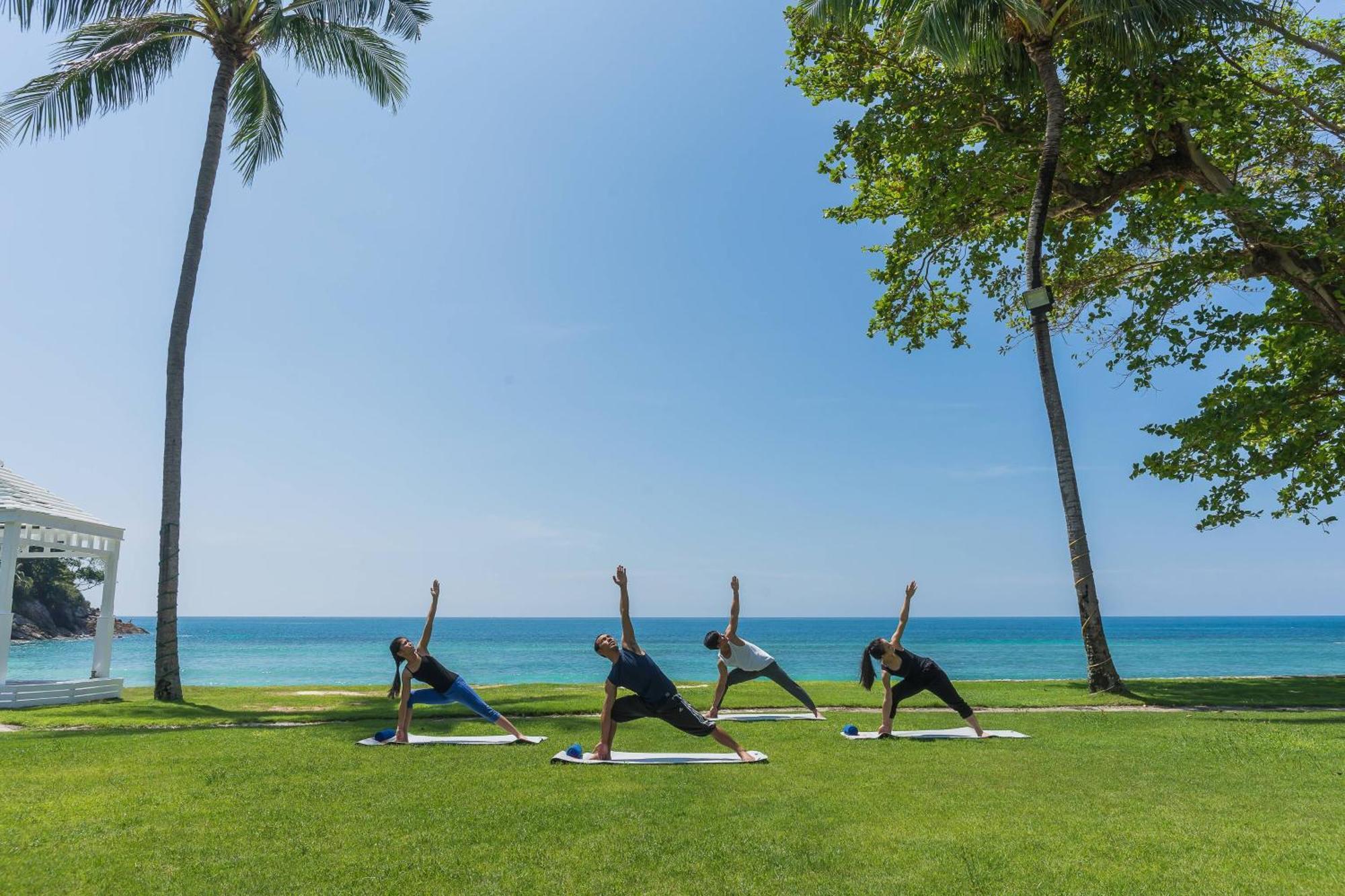 Phuket Marriott Resort & Spa, Merlin Beach Patong Exterior photo A yoga class at the beach