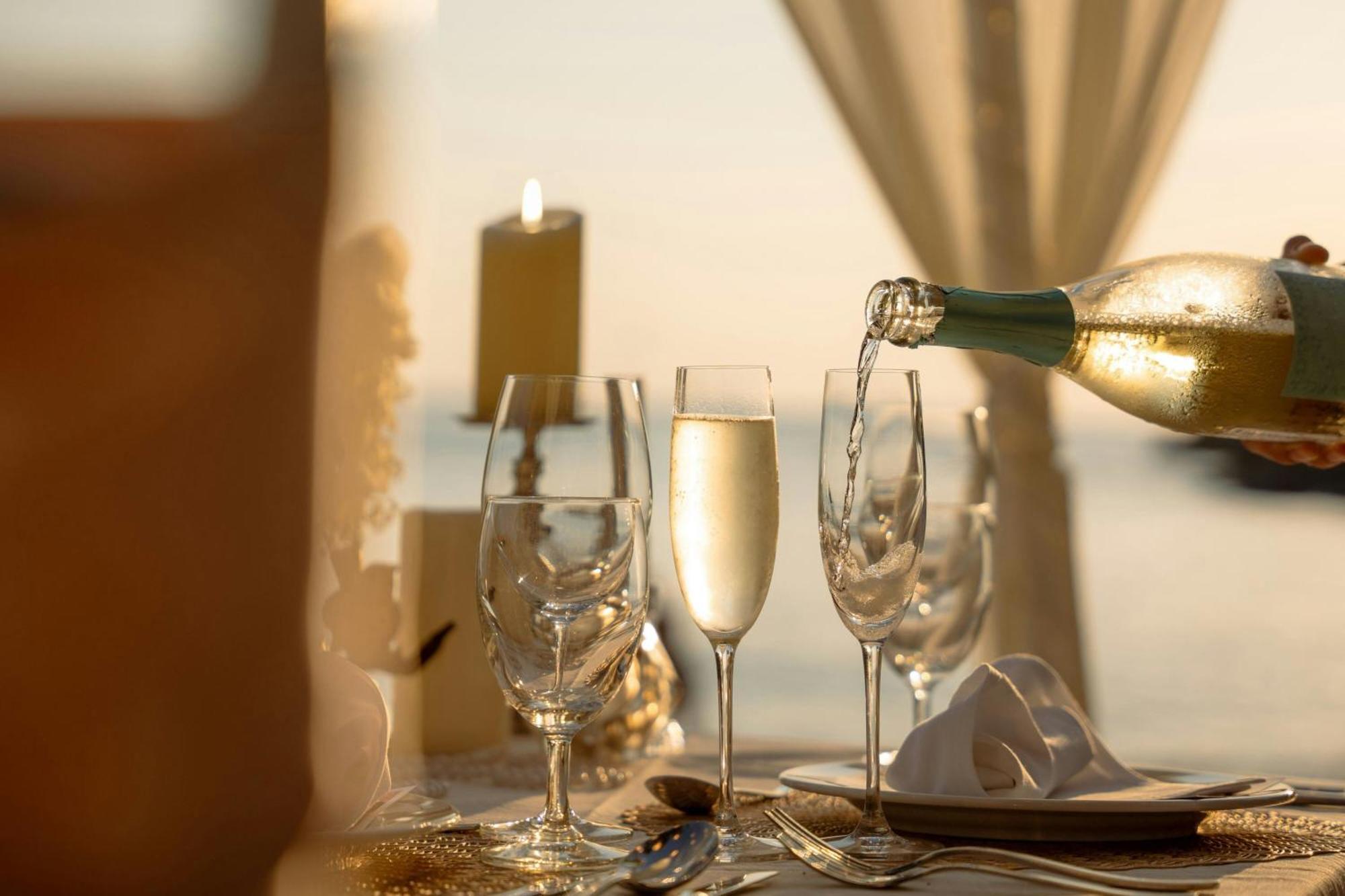 Phuket Marriott Resort & Spa, Merlin Beach Patong Exterior photo A bottle of champagne being poured into a glass